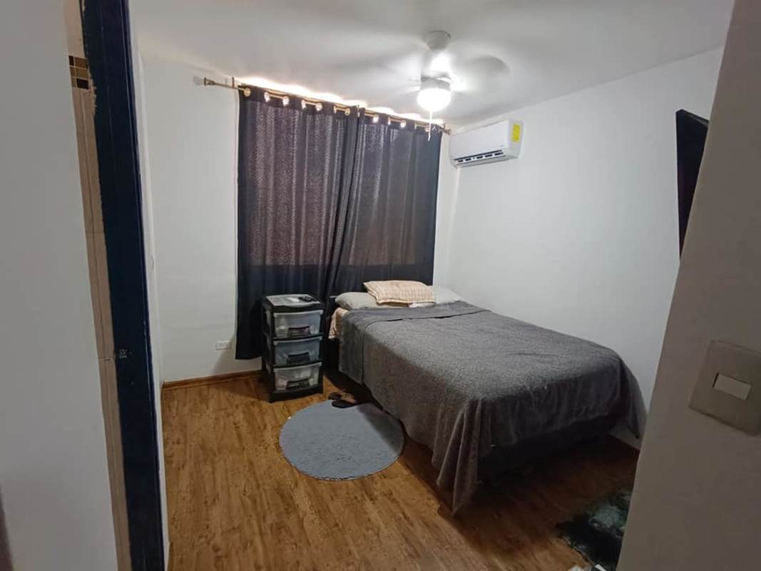 Bright living area with spiral staircase, kitchen with white cabinetry in PH Hato Pintado Panamá
