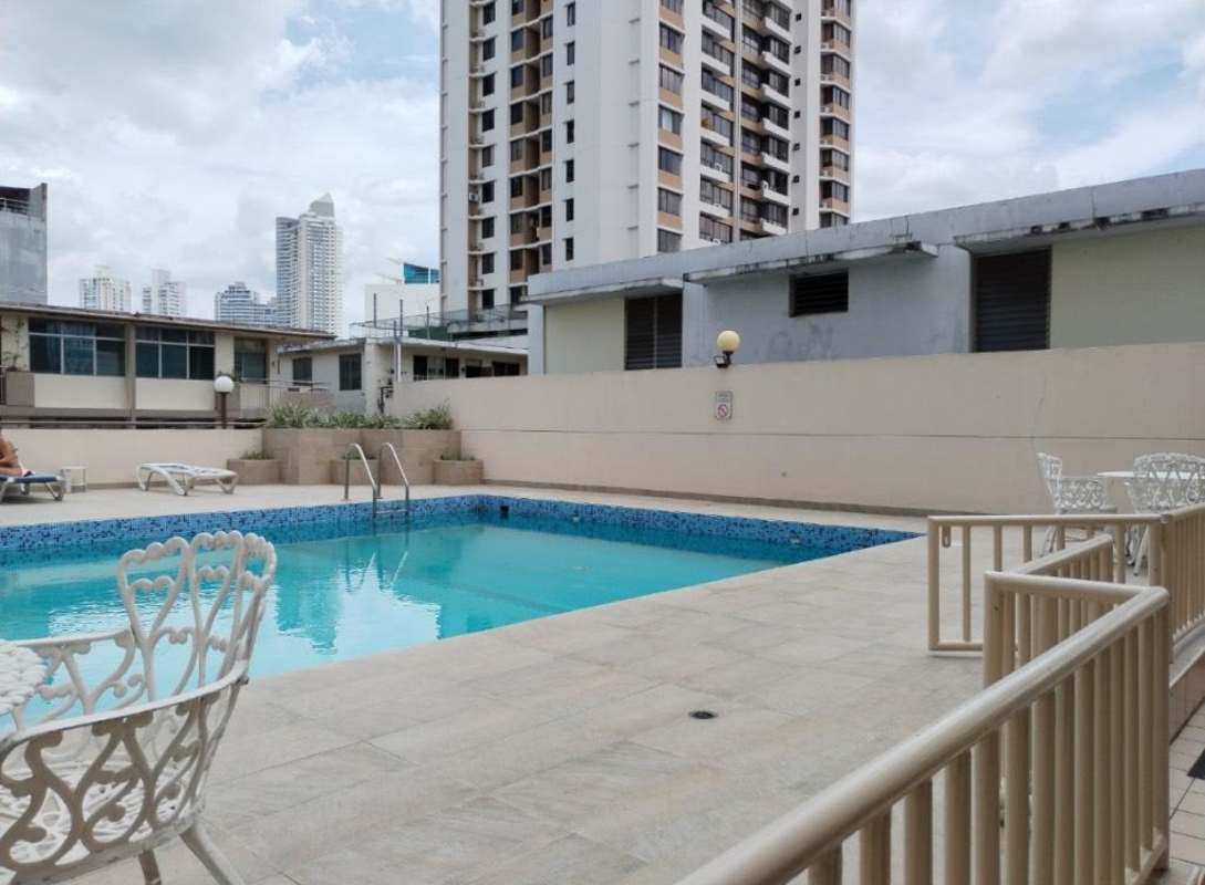 Swimming pool with sun loungers and modern fencing in Costa Bay community Panama for sale