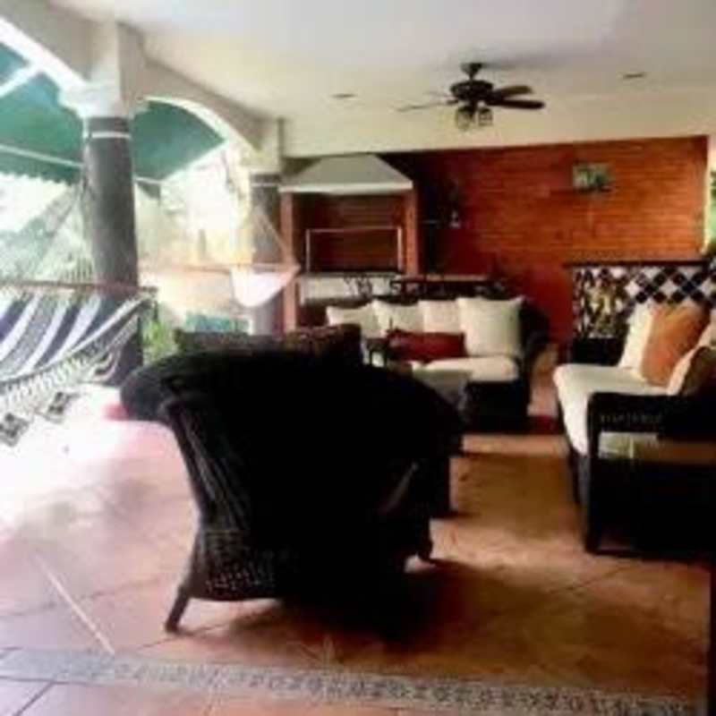 Spacious covered patio with ceiling fan, hammock in Costa Bay luxury family home for sale