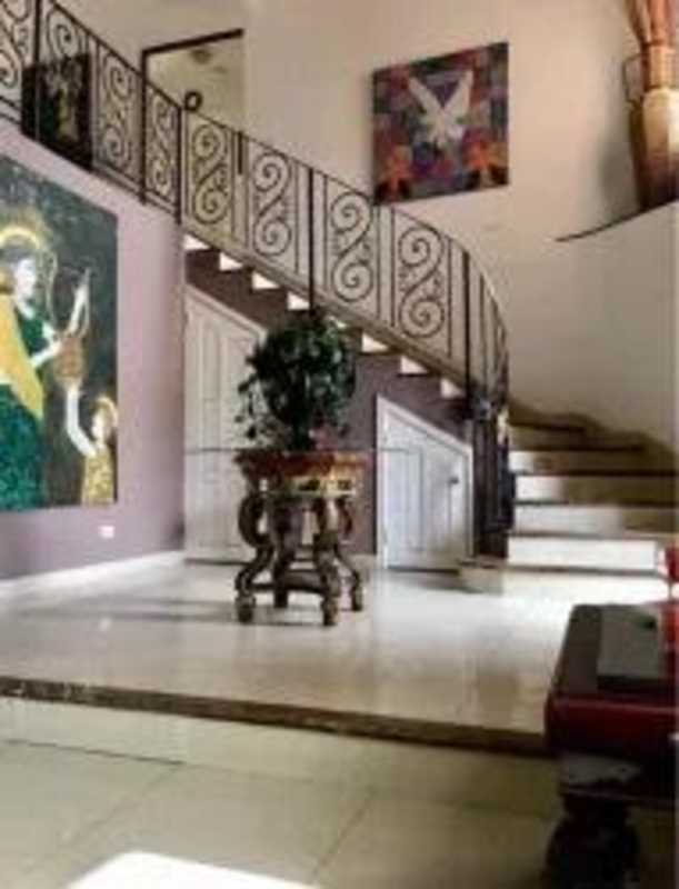 Entry foyer of luxury house in Costa Bay with marble staircase and ornate railing