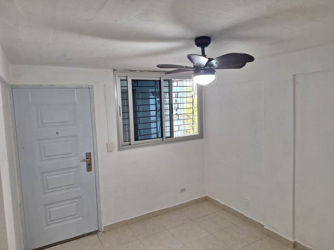 Small bedroom with built-in closet shelving tiled floor PH Santa María Betania Panama