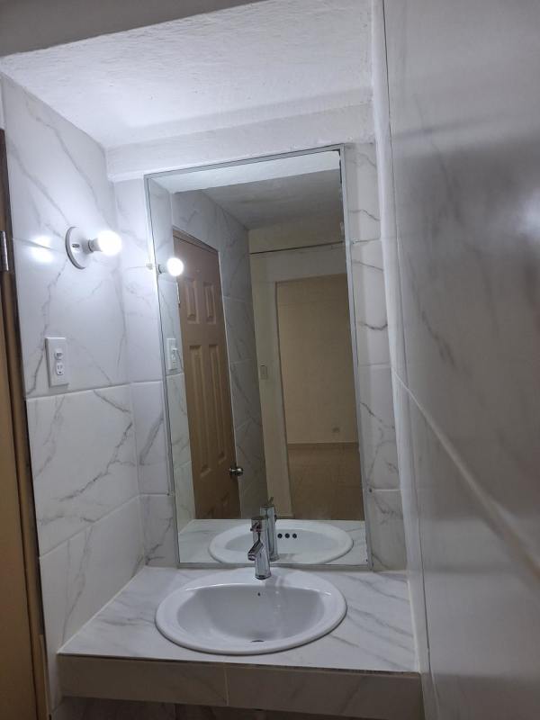Tiled bathroom with mirror sink and shower PH Santa María apartment Betania Panama