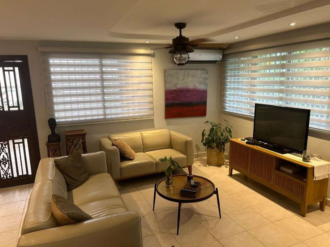 Traditional style living room with large windows, chandelier, tiled floors at Condado del Rey Panama house for sale