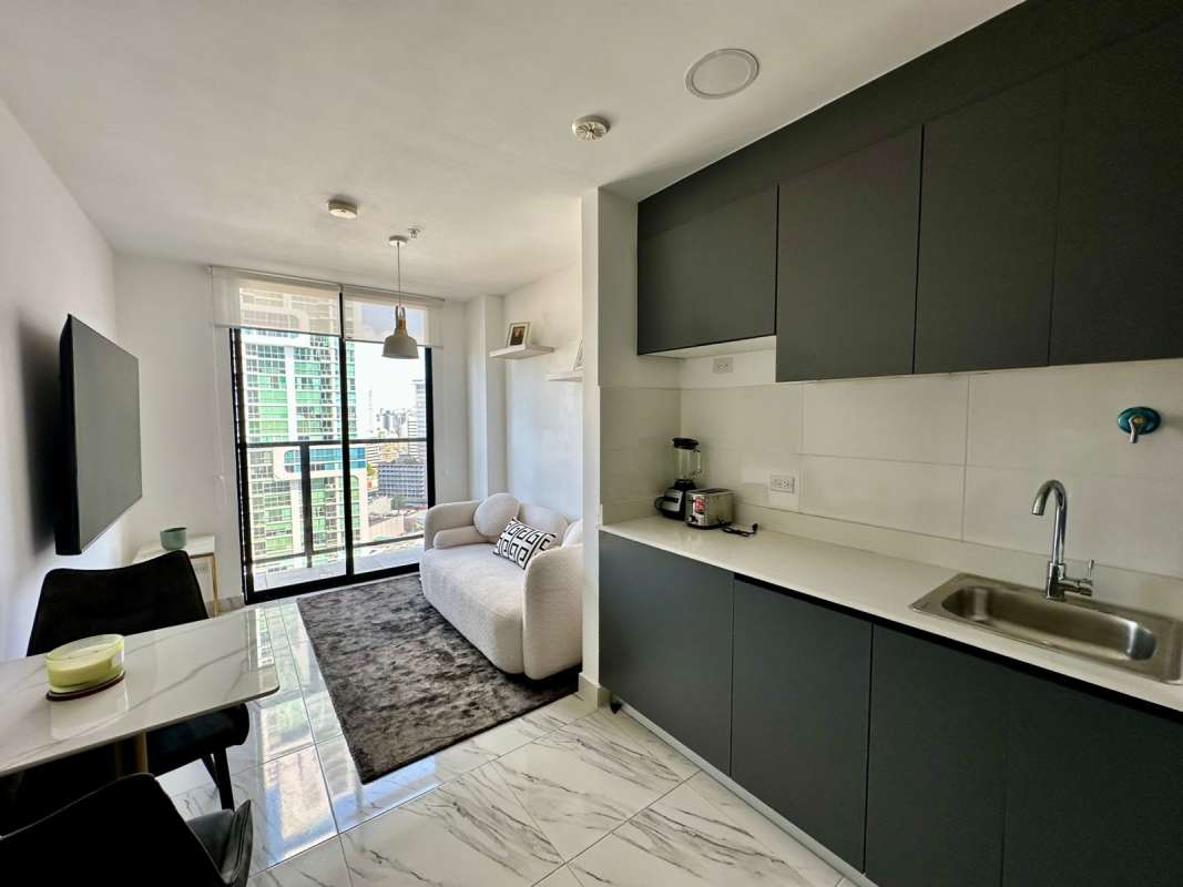 Open-plan living area modern kitchen and balcony at PH Calle 50 Tower Panama City