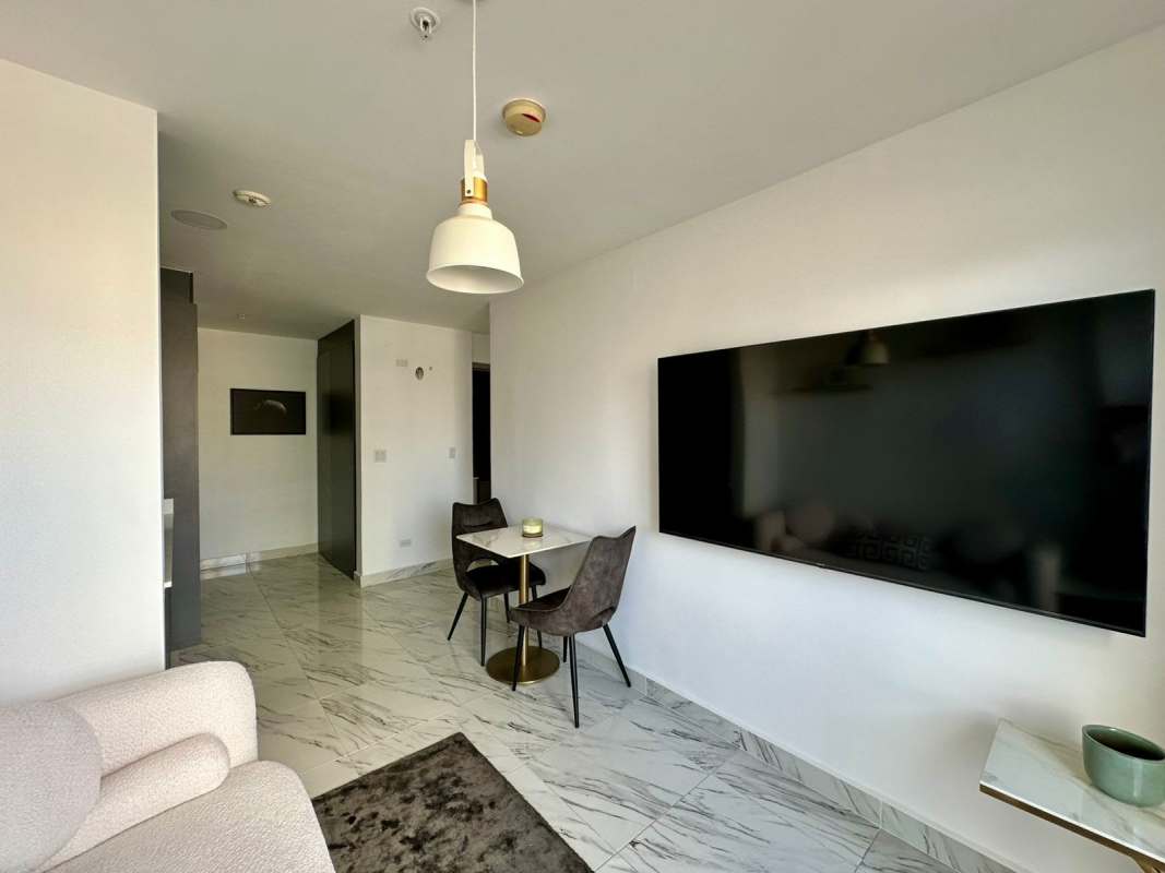 Modern minimalist bedroom with large window and skyline view at PH Calle 50 Obarrio Panama