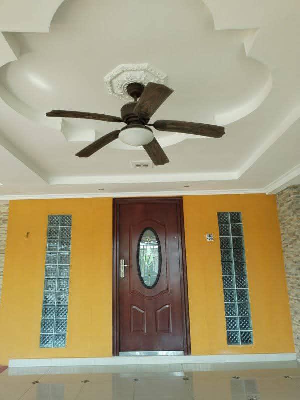 Covered entrance with wooden door, glass blocks, ceiling fan at Don Bosco Panama