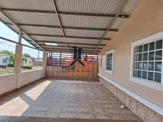 Spacious covered patio with tiled floor and privacy wall at Urbanización El Mirador