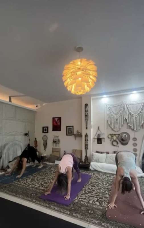 Yoga class space with bohemian decor patterned rug and wall hangings at wellness rental Clayton Panama