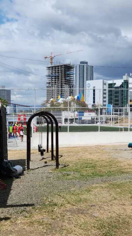 Exterior corridor with metal security door, potted plants and security bars Los Libertadores Panama