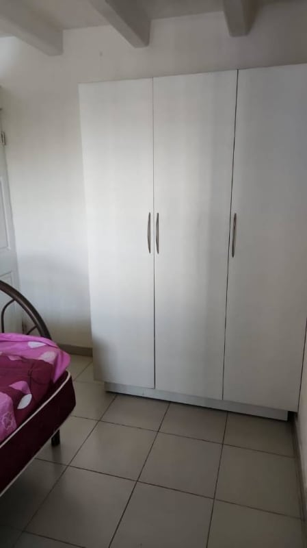 Bedroom with white wardrobe, tile flooring, white walls apartment in Los Libertadores San Miguelito