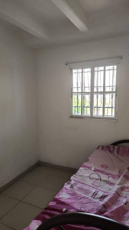 Bedroom with tile floor and window security bars Los Libertadores Panama City Panama