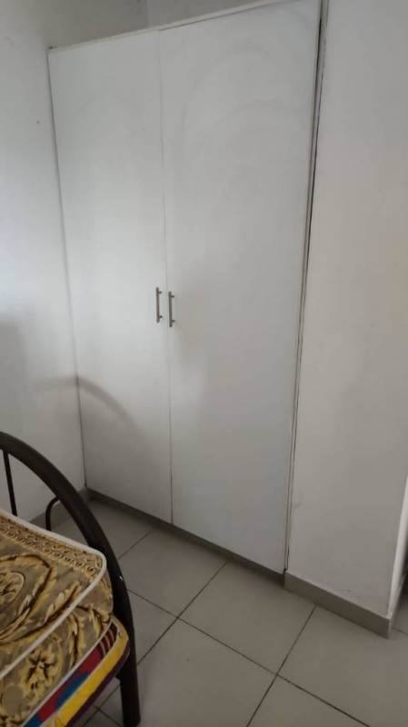 Bedroom with tile floor, window grill and bedframe Los Libertadores Panama apartment