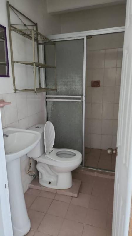 Small bathroom with pedestal sink and glass shower door Los Libertadores apartment Panama