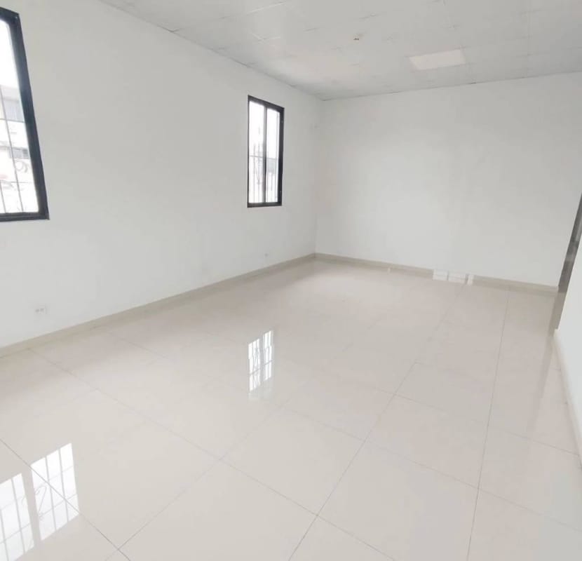 Indoor staircase with metal railing wood handrail at commercial property in Panama City
