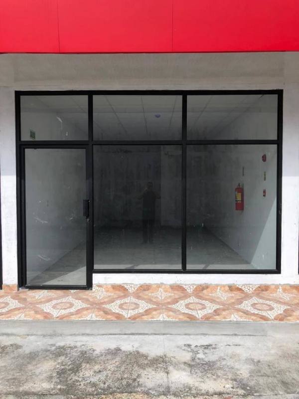 Glass front retail unit with red fascia at commercial property Parque Lefevre Panama City