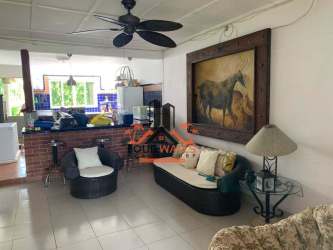 Spacious living room with tropical style and open floor plan in Coronado house for sale