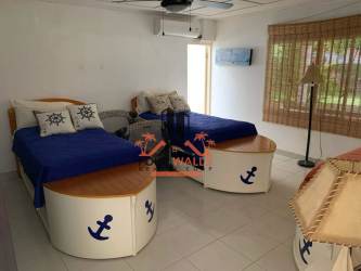 Bedroom with AC, ceiling fan, natural light in Playa Coronado beach house for sale Panama