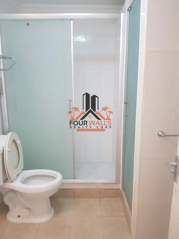 Clean bathroom with glass enclosed shower and ceramic tiles in Villas de Las Fuentes Panama