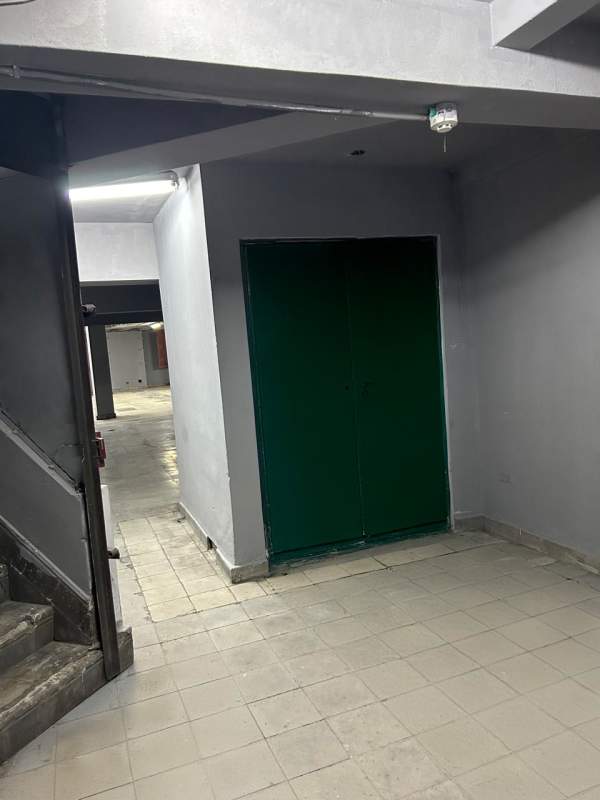 Large empty basement industrial-style storage with concrete floor tiled walls Calidonia