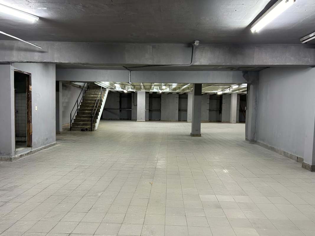 Open unfinished warehouse basement with tiled floors concrete pillars Calidonia Panama