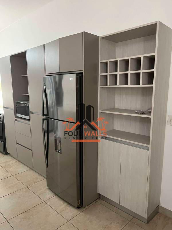 Kitchen with gray cabinetry, built-in fridge, stainless appliances inside PH Amador Hill Panama City