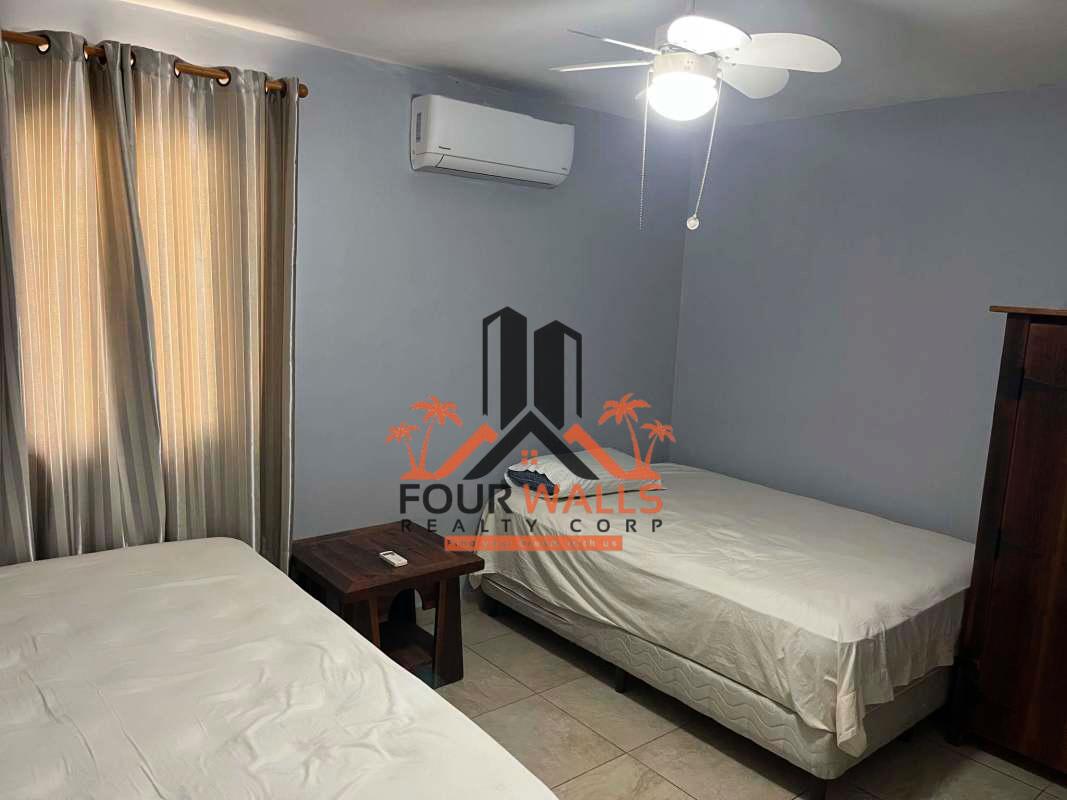 Covered tiled balcony with arched opening overlooking lush greenery PH Amador Hill Panama