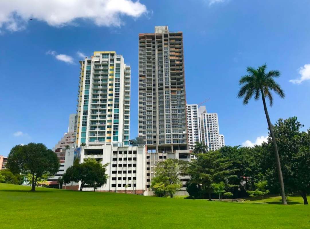 Modern towers with multiple balconies overlooking green park in Carrasquilla Panama City