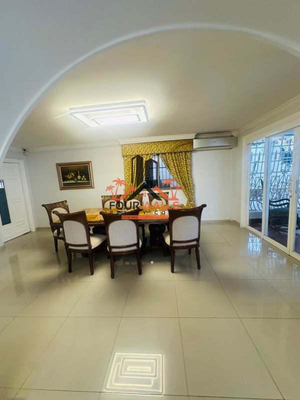 Spacious dining room with large table, patio view, split AC at Villa de las Fuentes Panama City