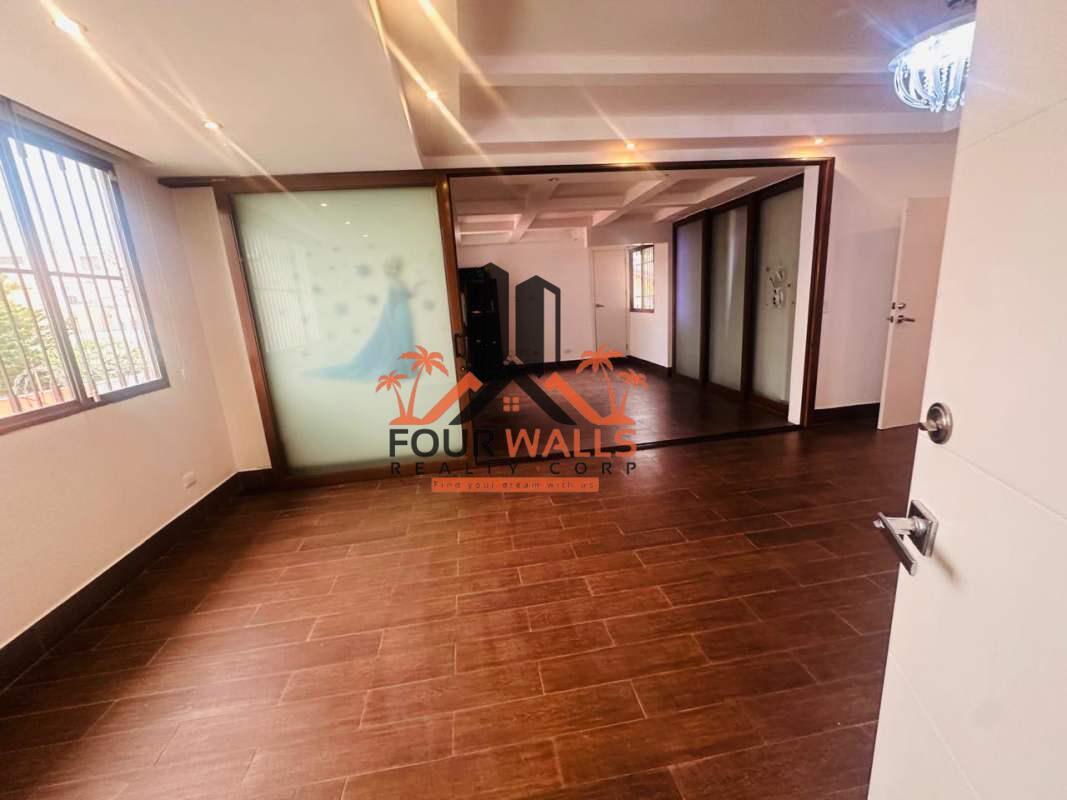 Large walk-in closet with built-in wood shelves and drawers Villa de las Fuentes Panama City