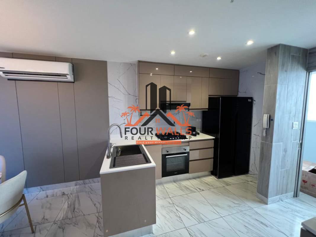 Modern kitchen with marble backsplash, built-in appliances and sleek cabinetry in PH The Sands Panama