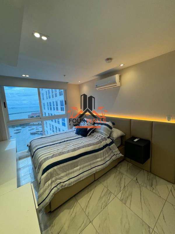 Modern living room with floor-to-ceiling windows, ocean views, marble tiles in PH The Sands Panama