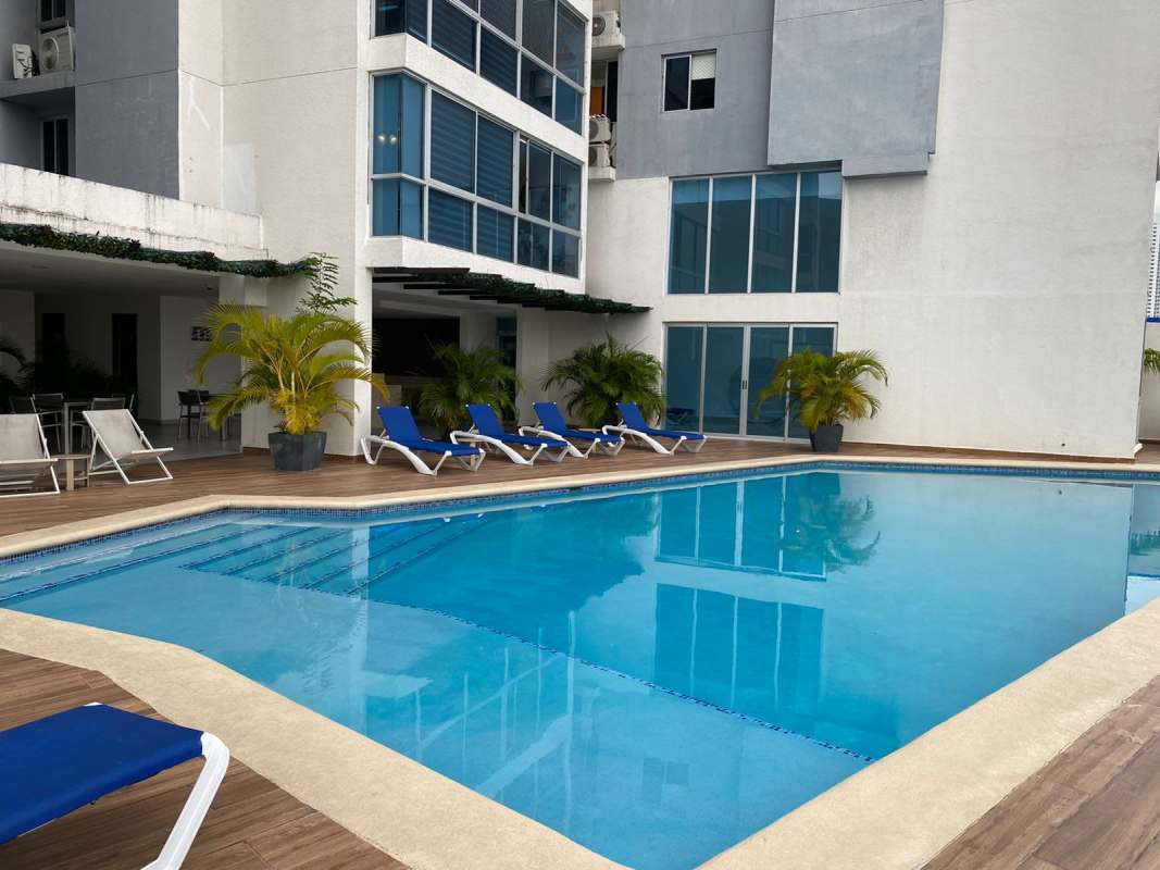 Outdoor swimming pool area with sun loungers at Coral Tower Carrasquilla Panama