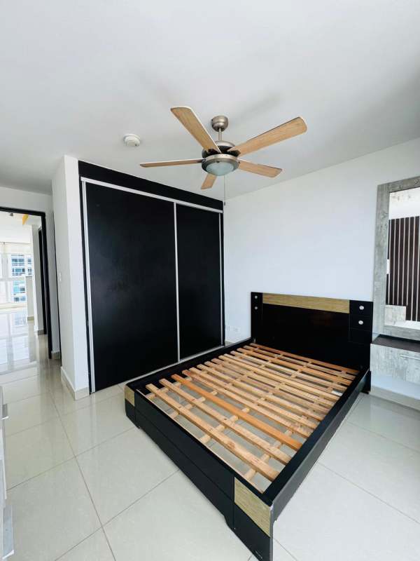 Living room with large windows offering park and skyline views in PH Coral Tower Panama