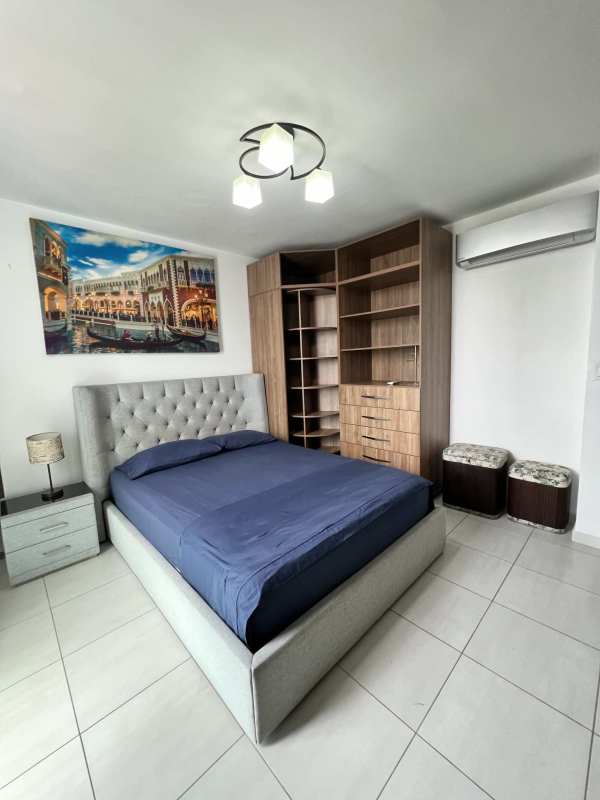 Bright master bedroom built-in closets large window with blinds and city view in PH Vista Hermosa