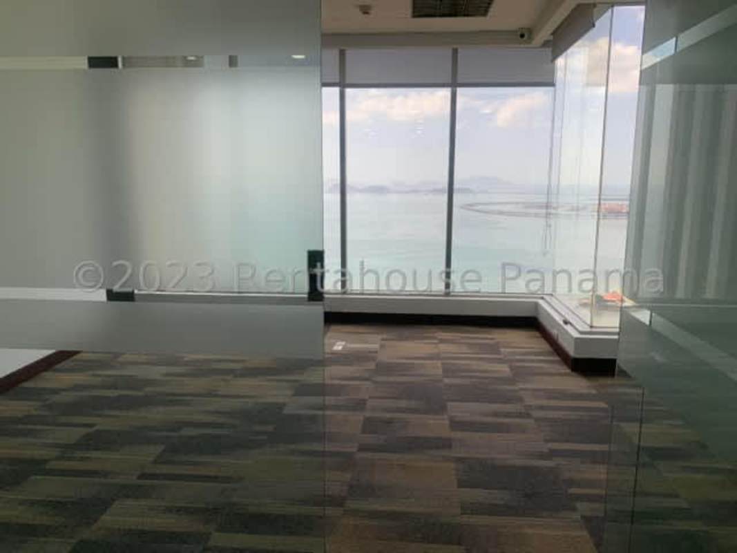 Reception area with glass doors and granite tiles at BICSA Financial Center Panama