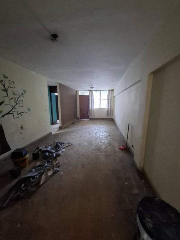 Spacious apartment interior under renovation with light walls and tiled floors Via España