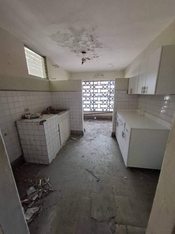 Secure gated entry of building with metal doors and tiled floors in Obarrio Panama