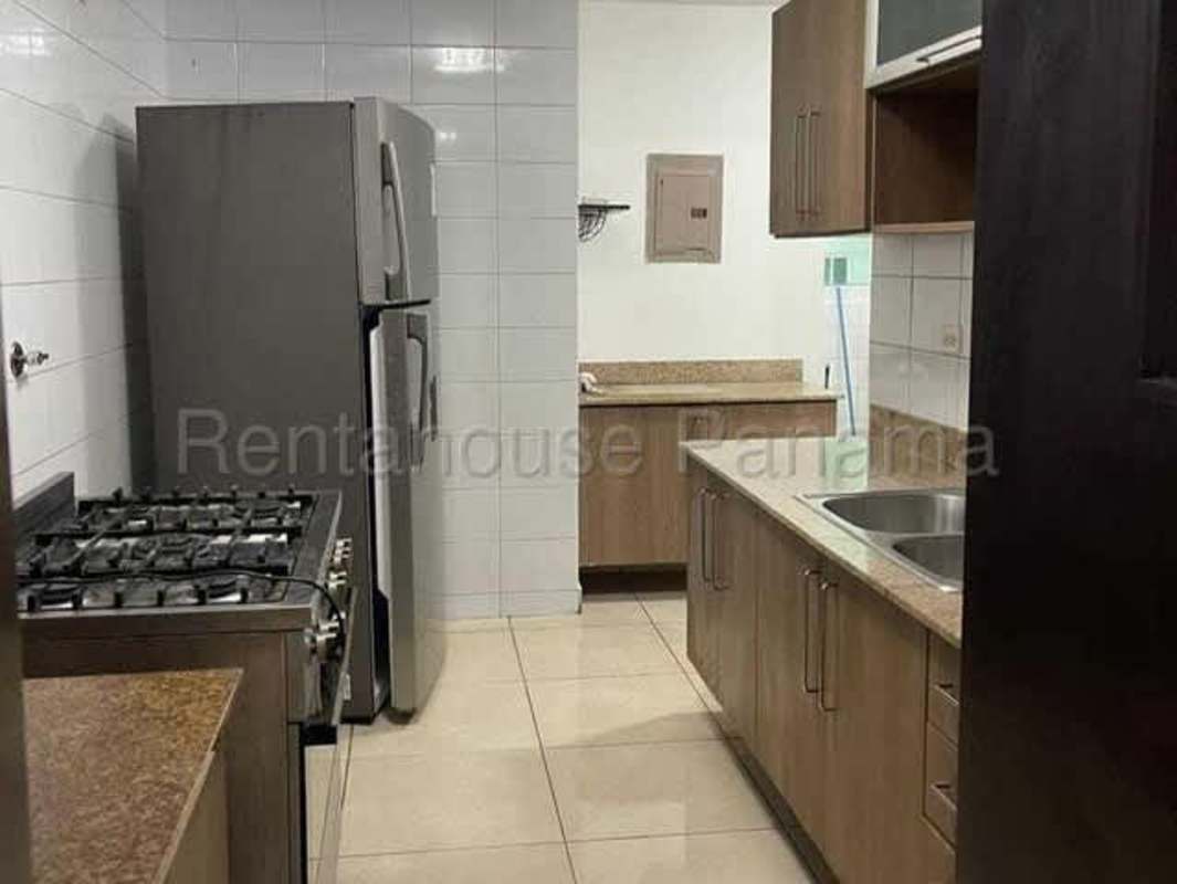 Modern kitchen with granite counters and wood cabinetry PH Kings Park Condado del Rey Panama