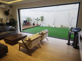 Modern open layout living room with garden access in Panama Pacifico River Valley house