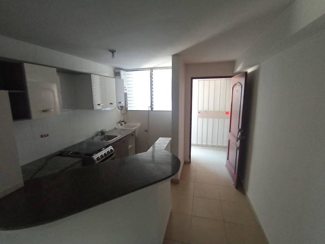 Bathroom with walk-in shower, sink, and tile walls in Bella Vista Garden Panama