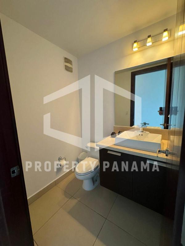 Modern bedroom with large windows featuring panoramic city and ocean views in PH Oceanaire