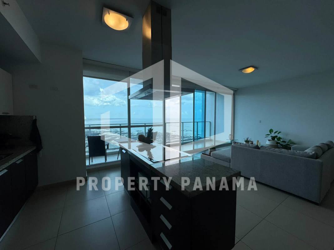 Modern kitchen and living area with panoramic coastal views and access to balcony in PH Oceanaire