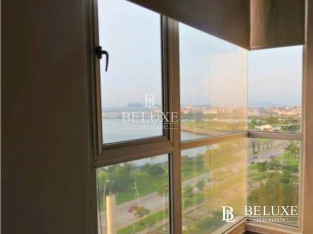 Balcony with colored glass railing offering ocean and historic district views at PH Element Panama City