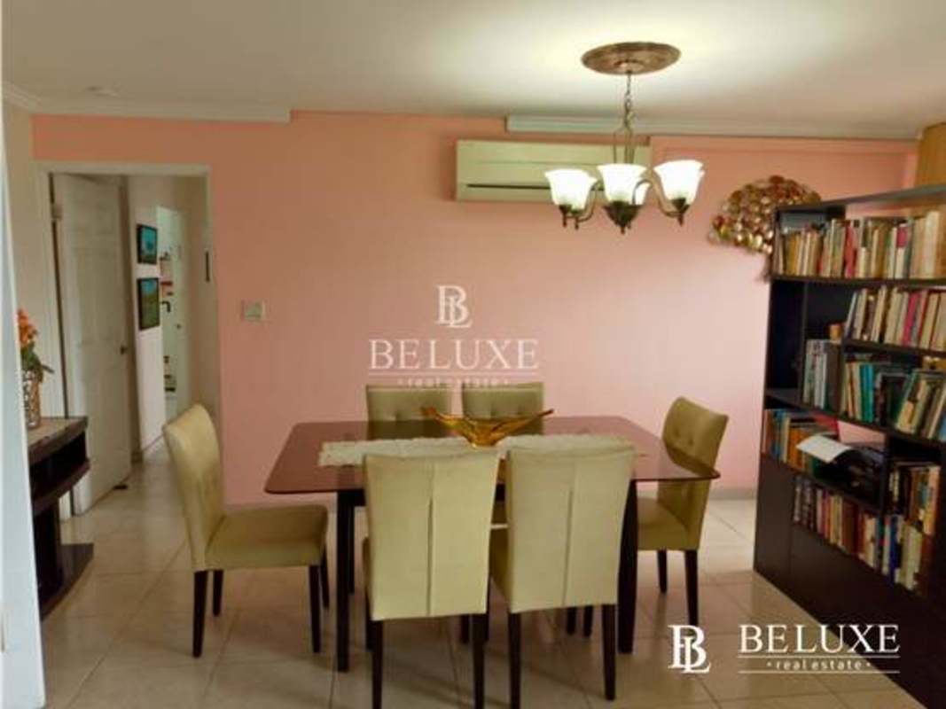 Dining area chandelier bookshelves PH Arrecife Punta Paitilla Panama apartment buy