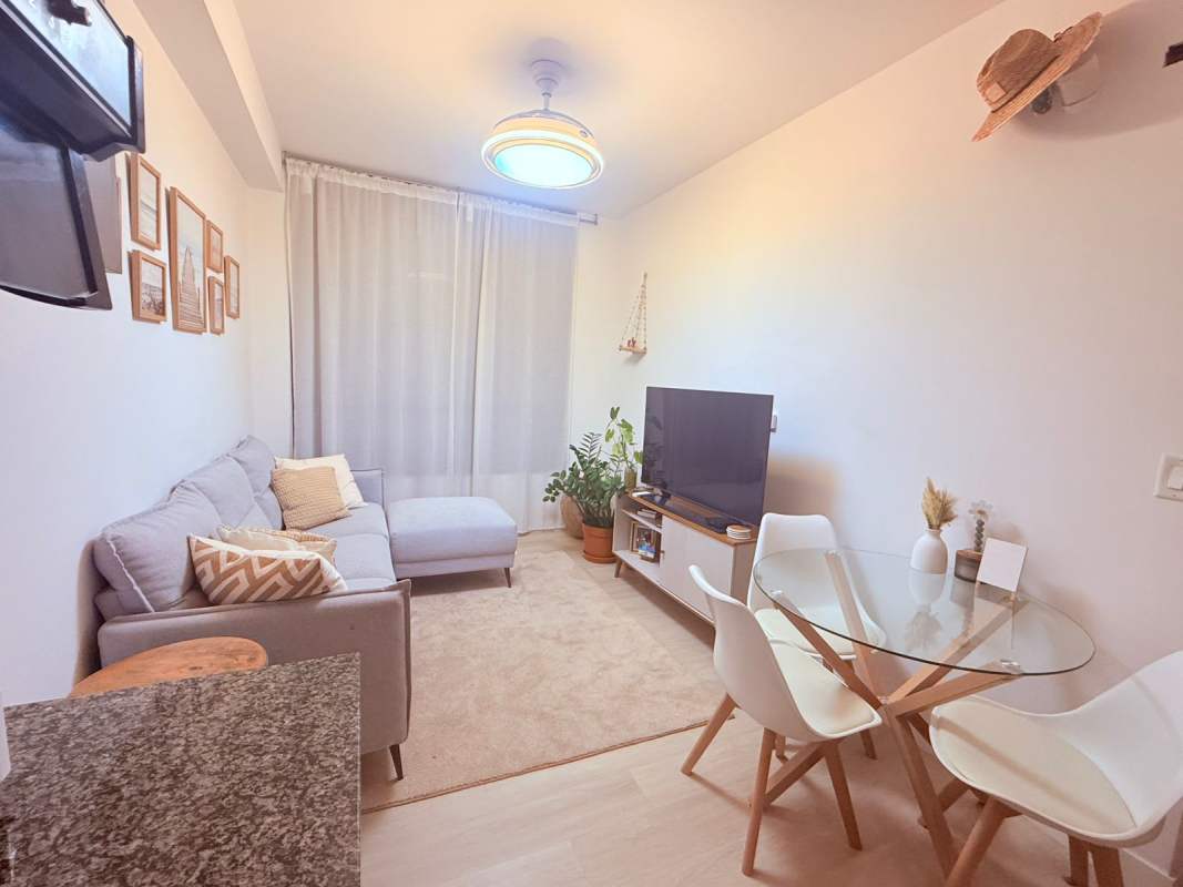 Bedroom featuring wall-mounted TV, AC, closet and modern minimalist decor PH Quatrium