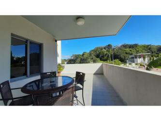 Open kitchen with quartz tops, appliances, and breakfast bar PH Mosaic