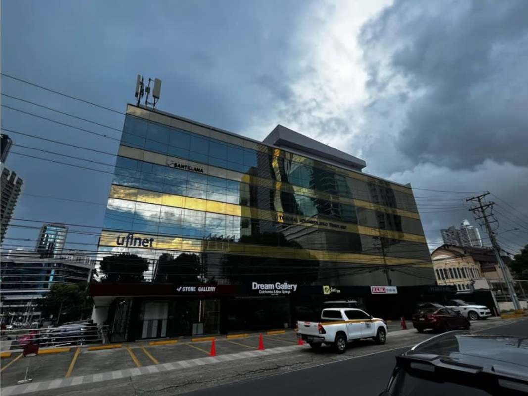 Empty modern commercial locale with white walls, black floor, recessed lights in Obarrio Panama