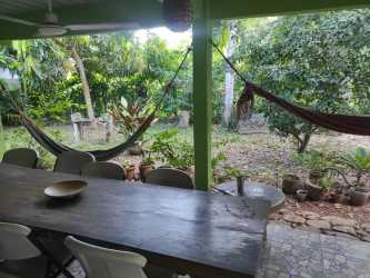 Contemporary bathroom with marble tiles, double vessel sinks, bathtub and natural finishes in eco-friendly Panama house