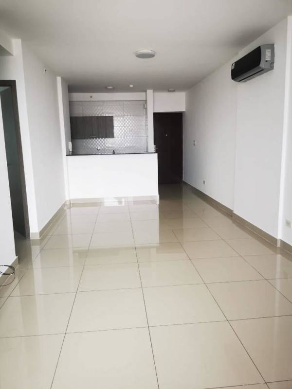 Modern living room with large glass sliding doors opening to balcony in PH Canvas Towers Panama City