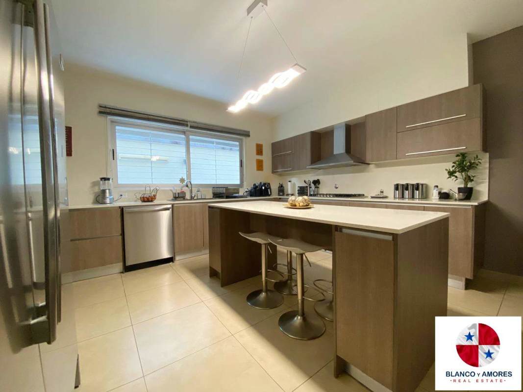 Modern gourmet kitchen with island, high-end appliances, quartz countertops at Dorado Village Condado del Rey Panama